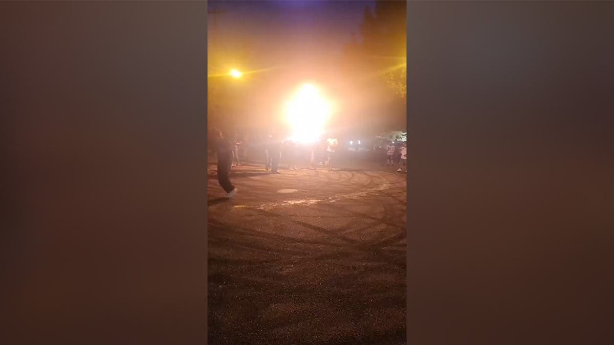 a ring of fire seen on a busy street at night