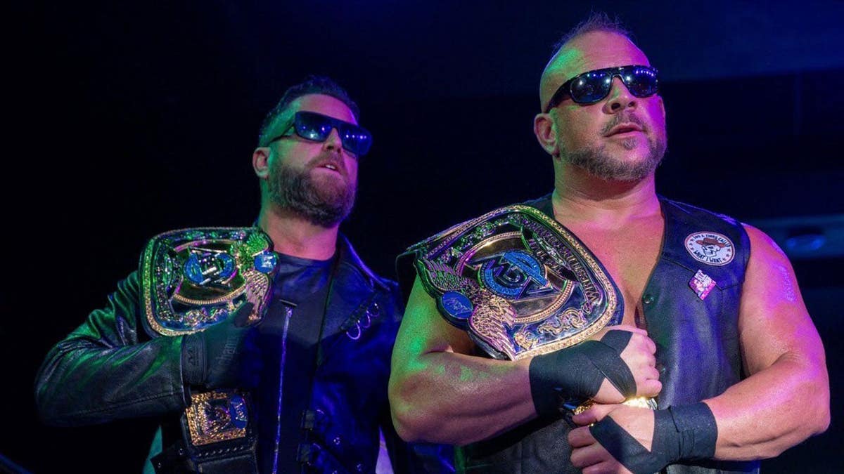 Hale Collins and Vik Dalishus hold the belts