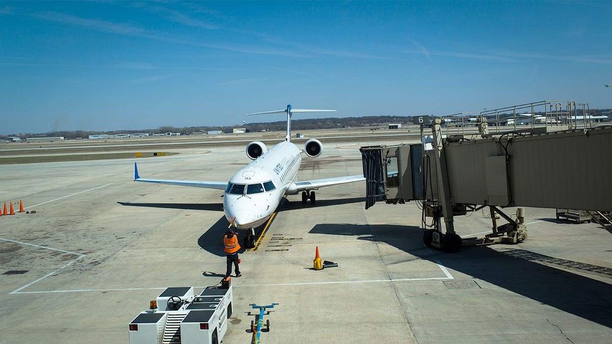An United Express plane arrives at a docking bay April 18, 2014, at the Madison, Wisconsin airport.