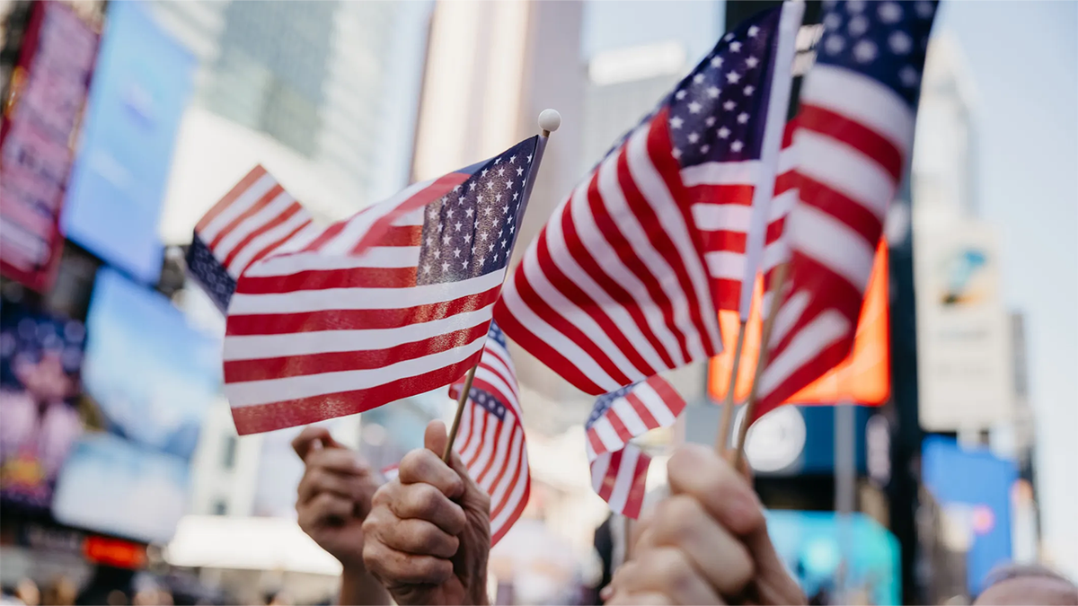 Small American flags being waved in New York City