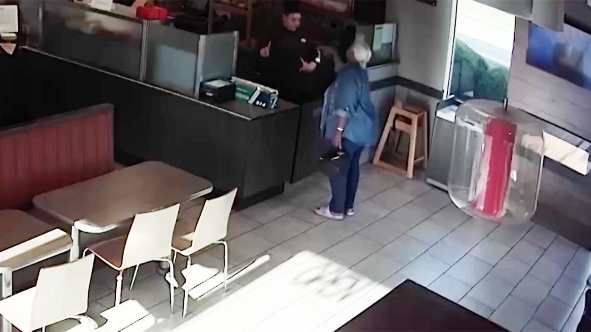 Anita Grayson speaking with a Tim Hortons employee inside a store
