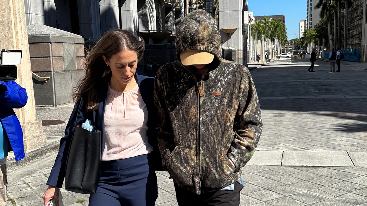 Anna Kepner's 16-year-old stepbrother walking outside a federal court building in Miami with his attorney