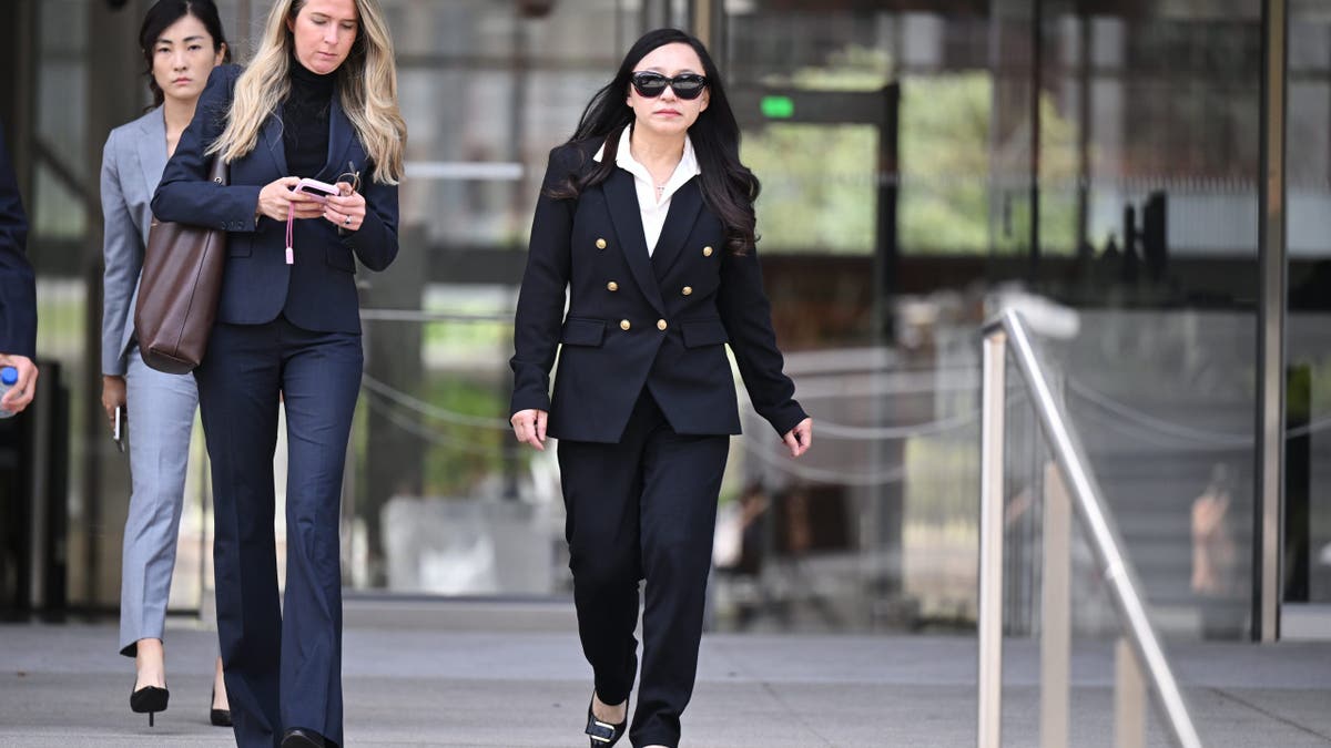 Eileen Wang leaves federal court with her attorney after pleading guilty to acting as an illegal agent of China