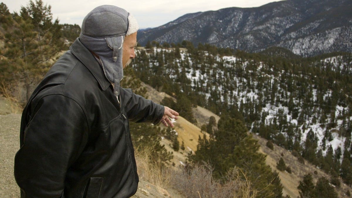 Benjaman Kyle gesturing down to the valley below in Colorado.