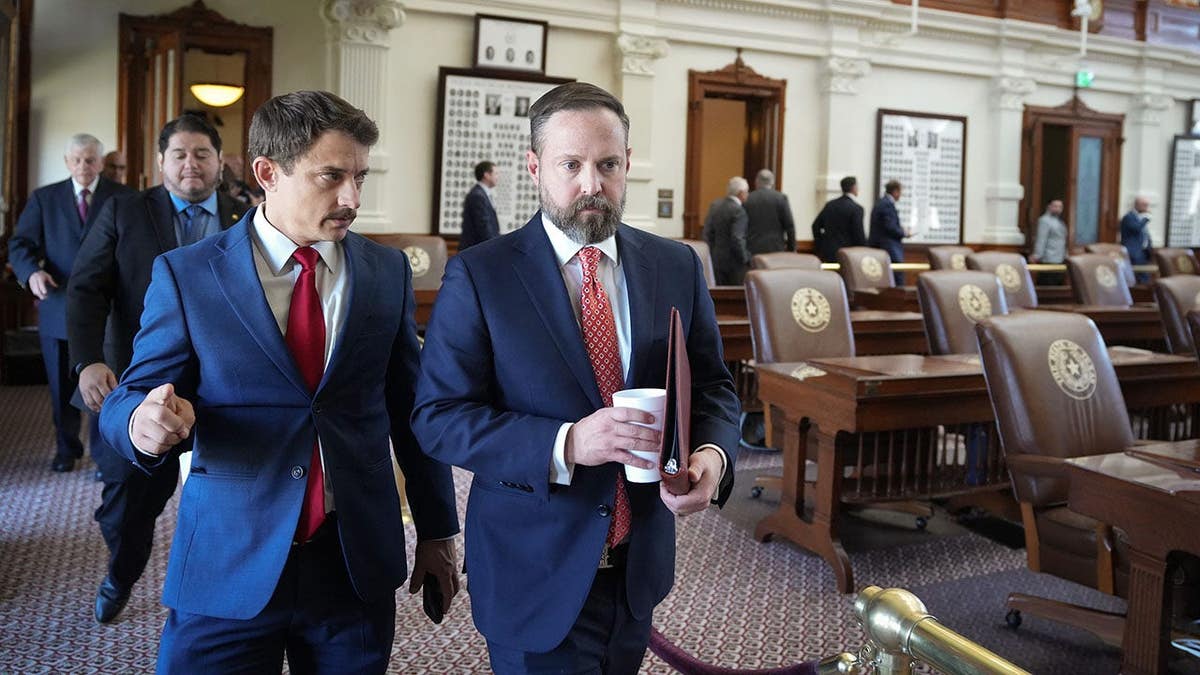 Rep. Briscoe Cain and Speaker Dustin Burrows walking outside the Texas Capitol