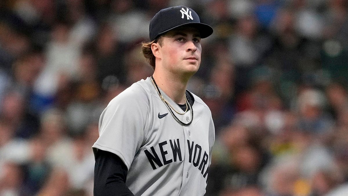 New York Yankees' Cam Schlittler walking to the dugout during a baseball game.