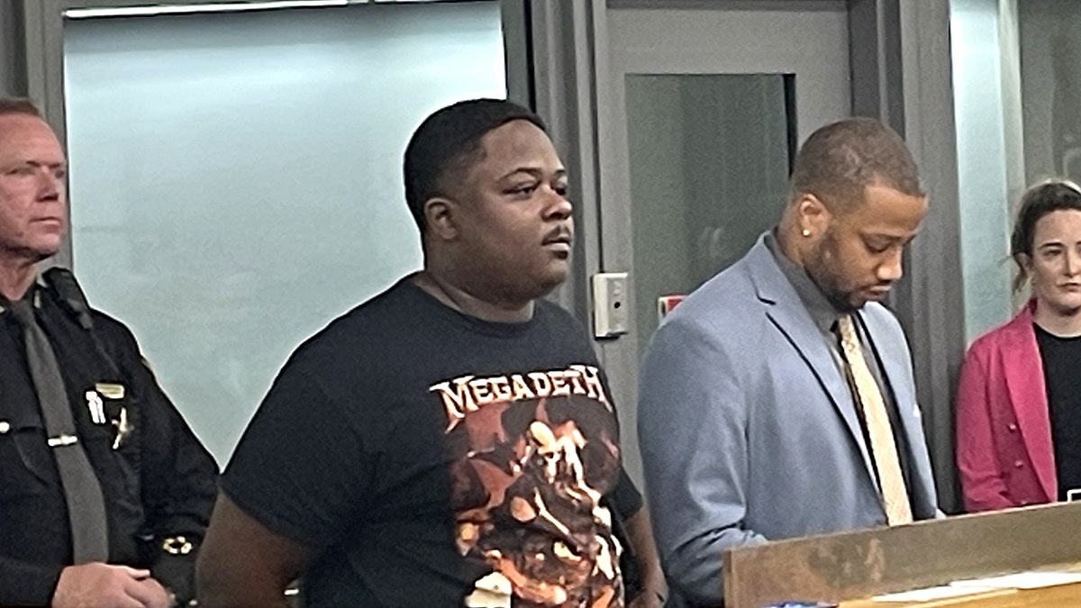 Gregory Wright standing in court wearing a gray shirt