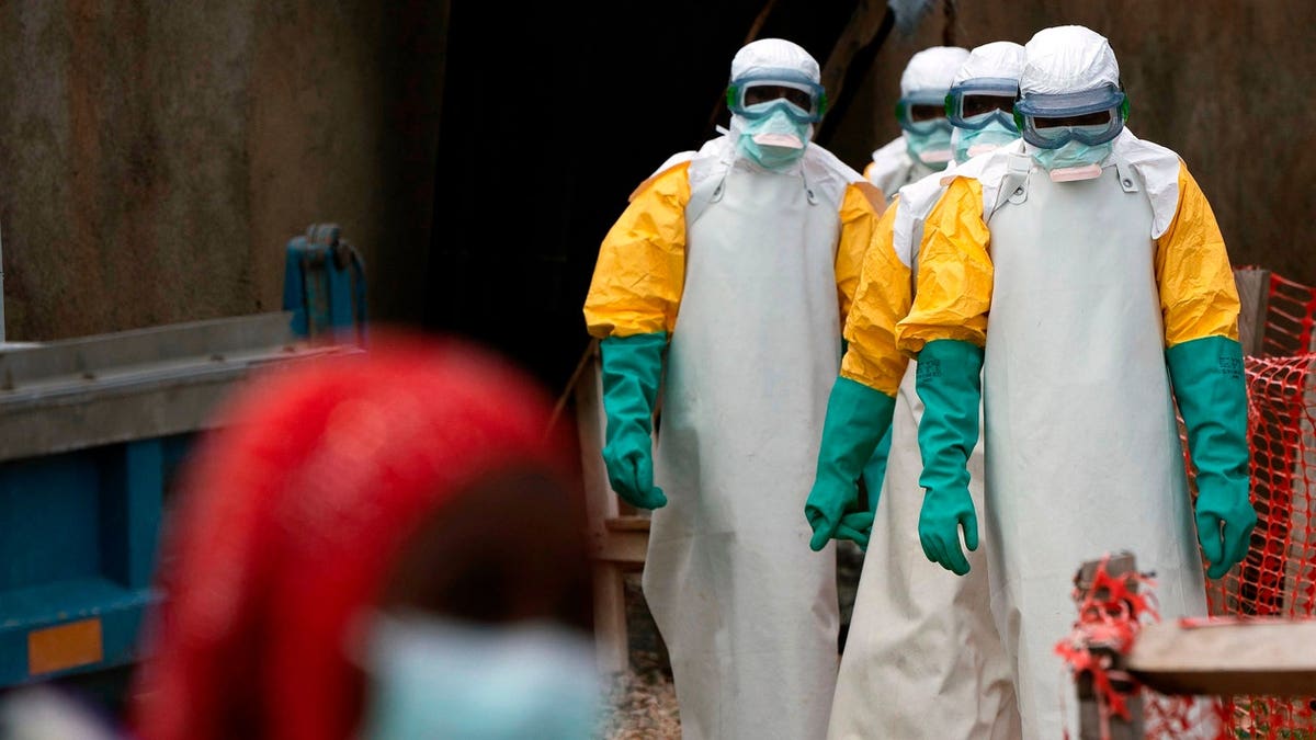 Health workers in protective gear starting shift at Ebola treatment center in Beni Congo
