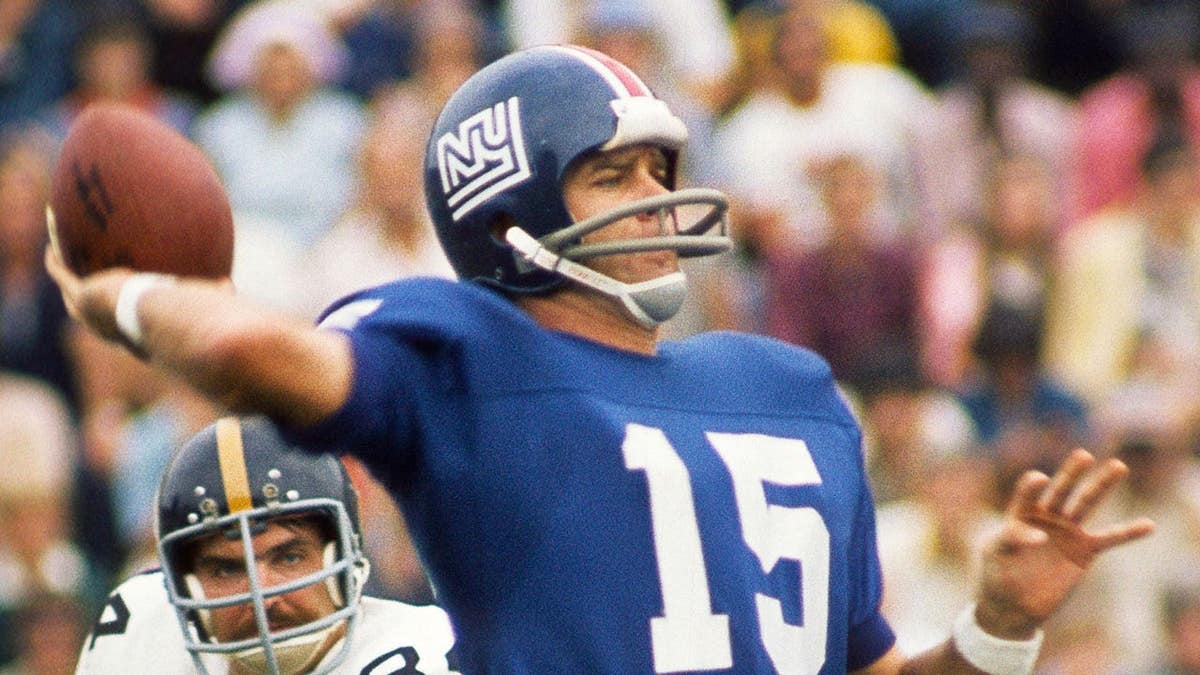 New York Giants quarterback Craig Morton throwing a football under pressure from Pittsburgh Steelers linebacker Andy Russell
