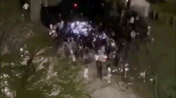A large group of teenagers fighting in a street in Washington, D.C.