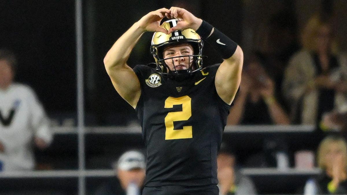 Vanderbilt Commodores quarterback Diego Pavia holding up a heart symbol at FirstBank Stadium