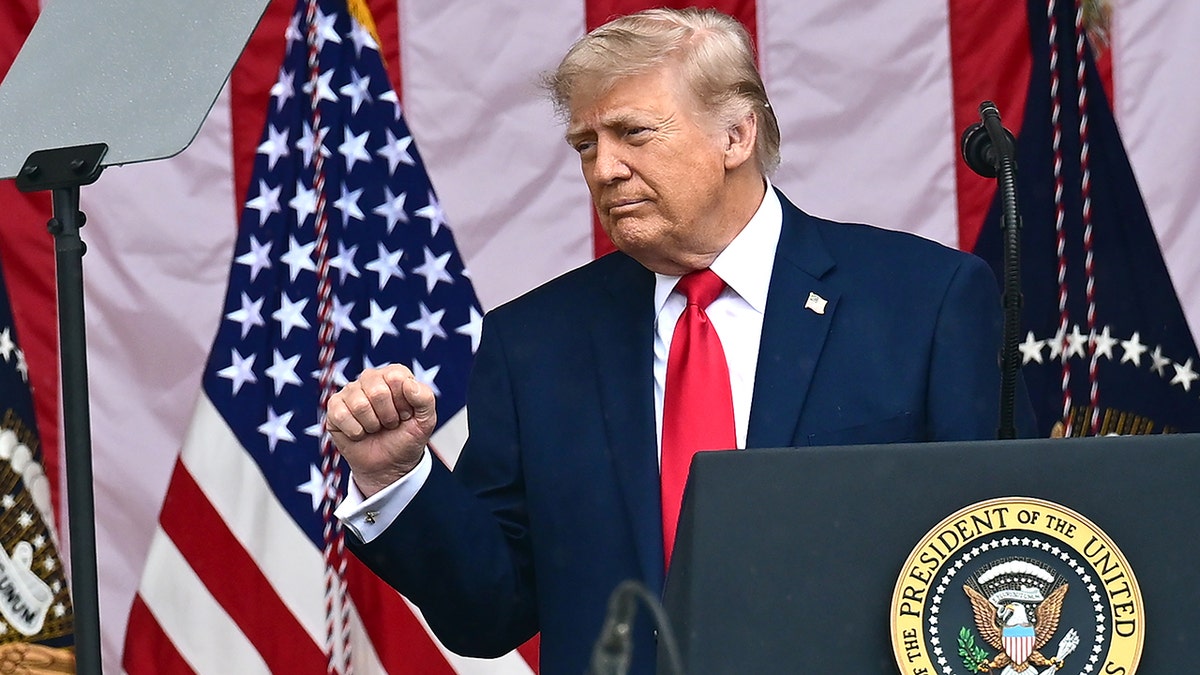 United States President Donald J Trump gesturing while speaking at Arlington National Cemetery amphitheater