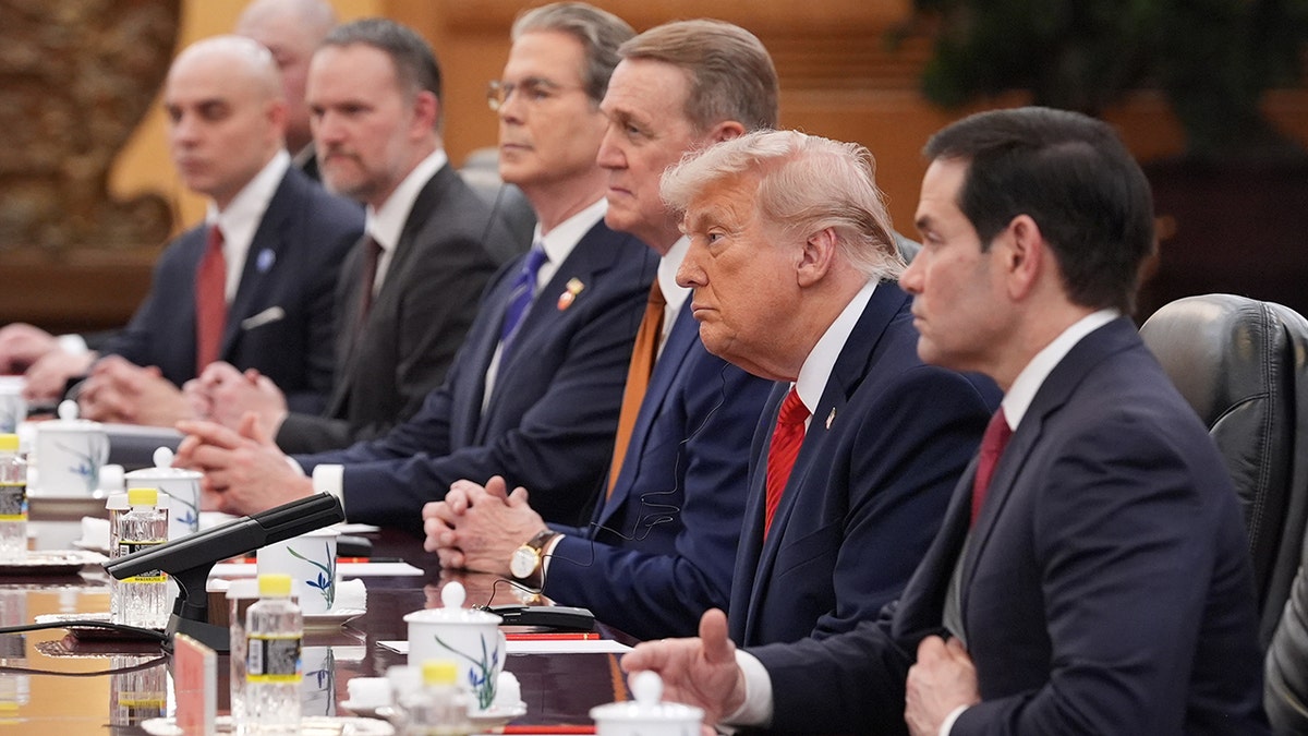 President Donald Trump listening to China's President Xi Jinping at the Great Hall of the People in Beijing