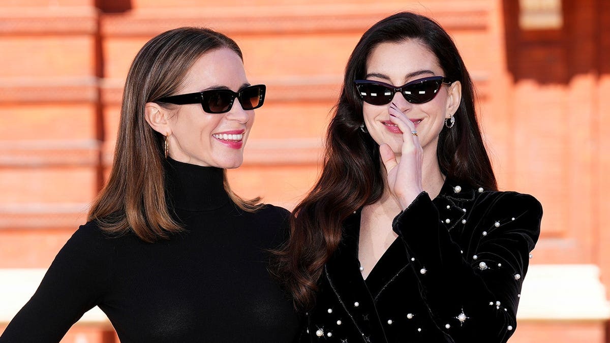 Emily Blunt and Anne Hathaway posing for photographers at a photo call