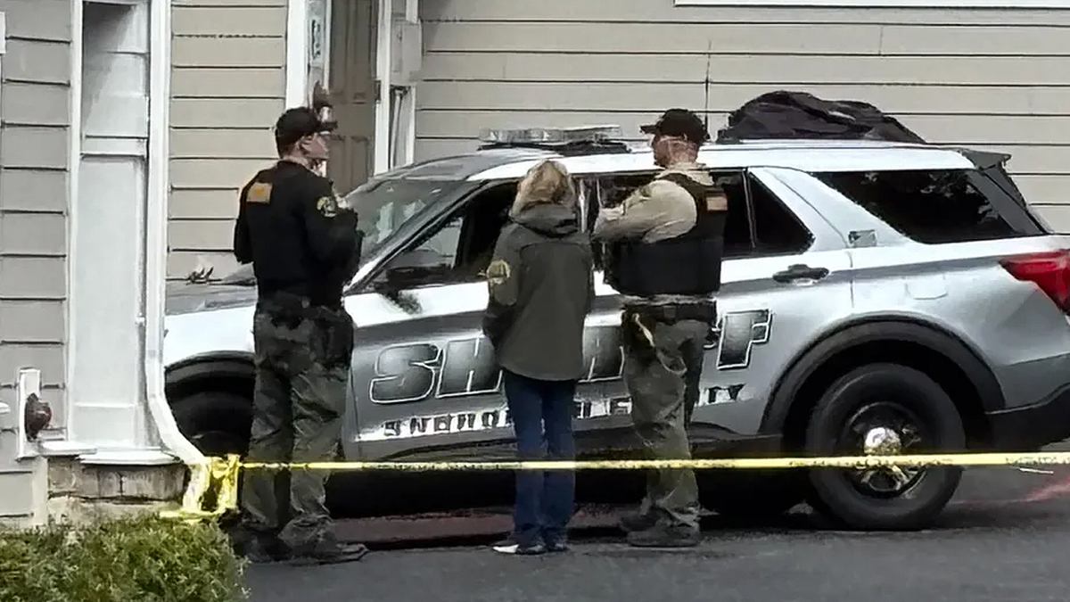 Police vehicles and crime scene tape block off a street in Everett, Washington during a stabbing investigation.