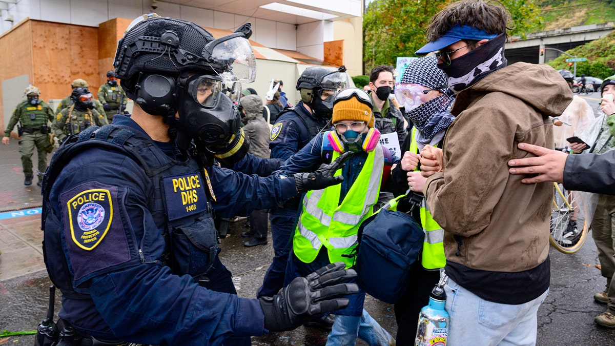 Federal agents clashing with anti-I.C.E. protesters outside U.S. Immigration and Customs Enforcement building in Portland