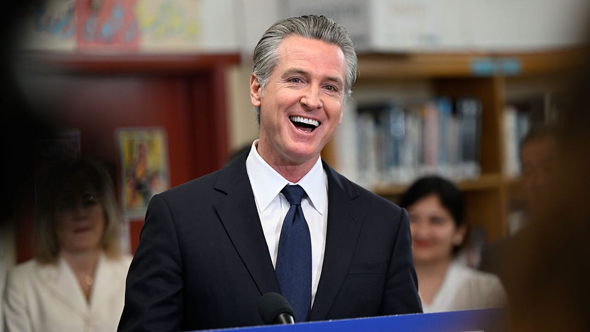 Governor Gavin Newsom speaking at a press conference at San Lorenzo High School