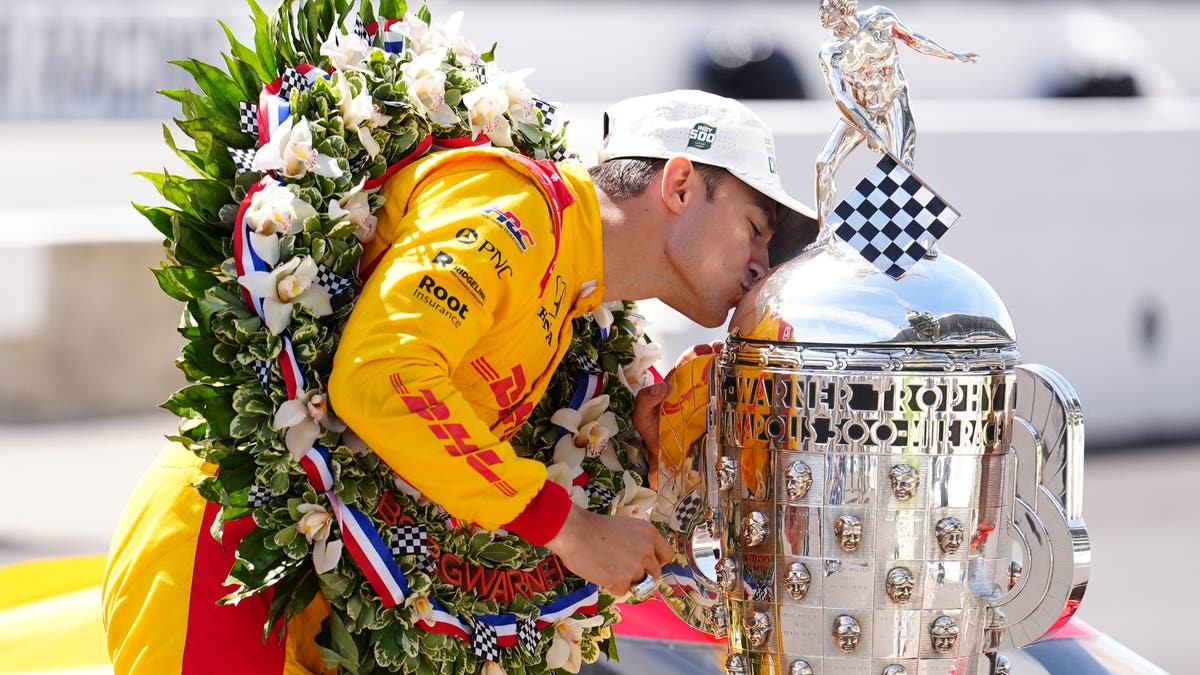 Alex Palou kisses the Borg-Warner Trophy after winning the 109th Running of the Indianapolis 500 in 2025. (Photo by Brian Spurlock/Icon Sportswire via Getty Images)