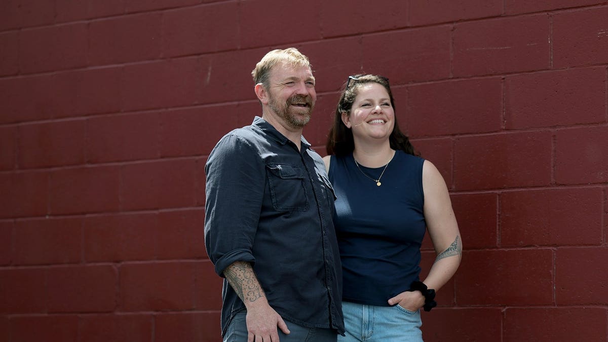 U.S. Senate candidate Graham Platner and his wife Amy Gertner standing together at an event