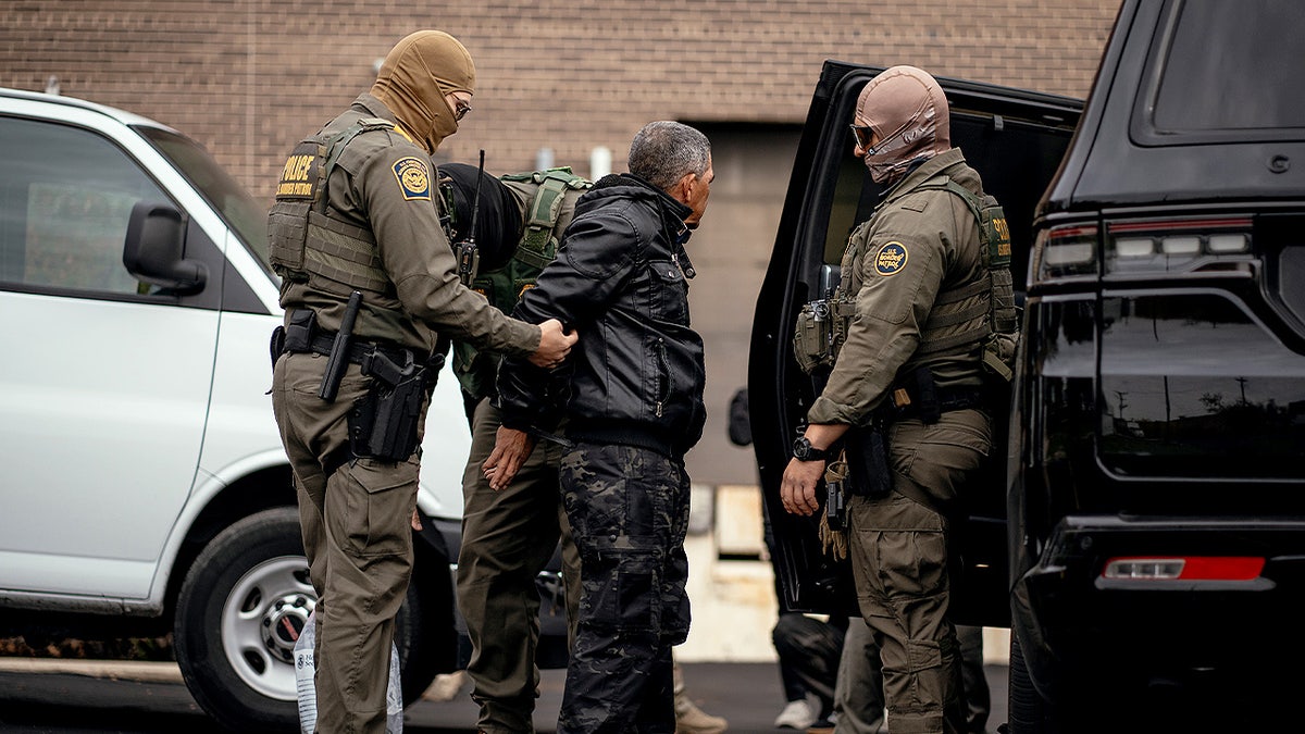 Chief Patrol Agent Gregory Bovino and federal officers detaining people in a parking lot in Chicago