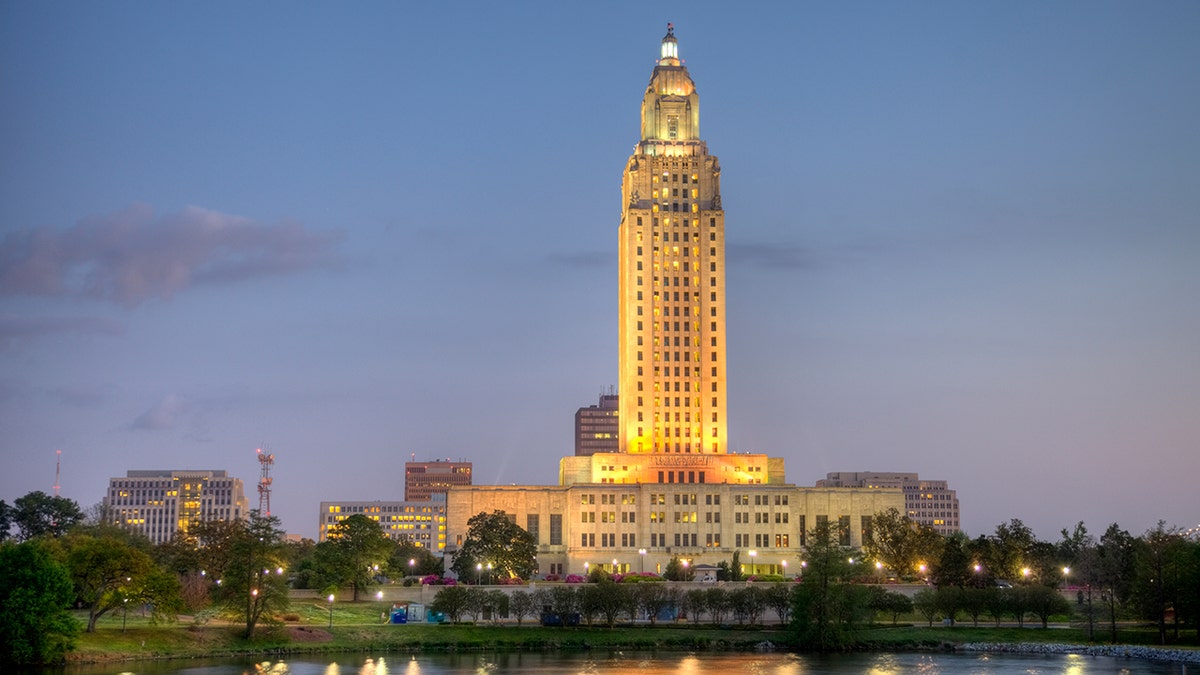 Louisiana State Capitol building standing near a small pond in downtown Baton Rouge