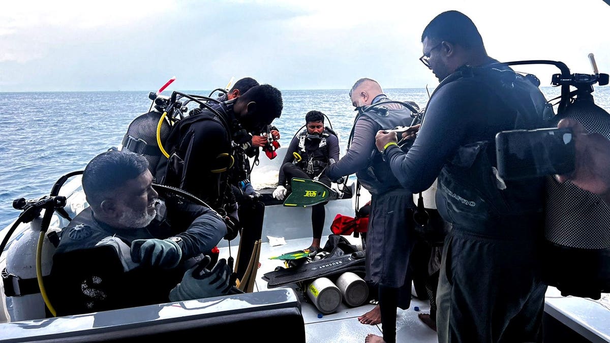 Divers preparing on a boat near Alimathaa Island in the Maldives