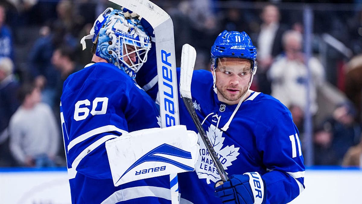 Max Domi #11 celebrates with Joseph Woll #60 of the Toronto Maple Leafs