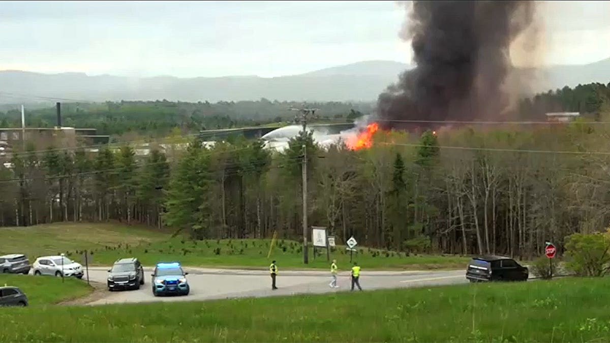 Shot of a fire with cars parked around