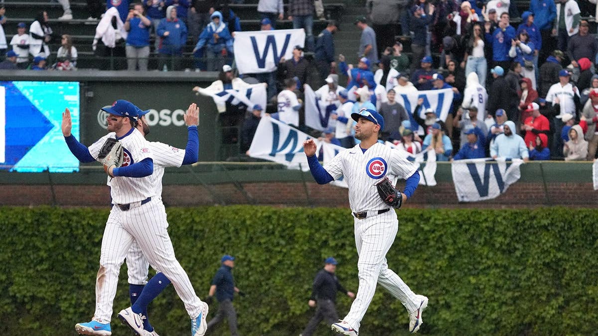 Michael Conforto celebrating on the field at Wrigley Field