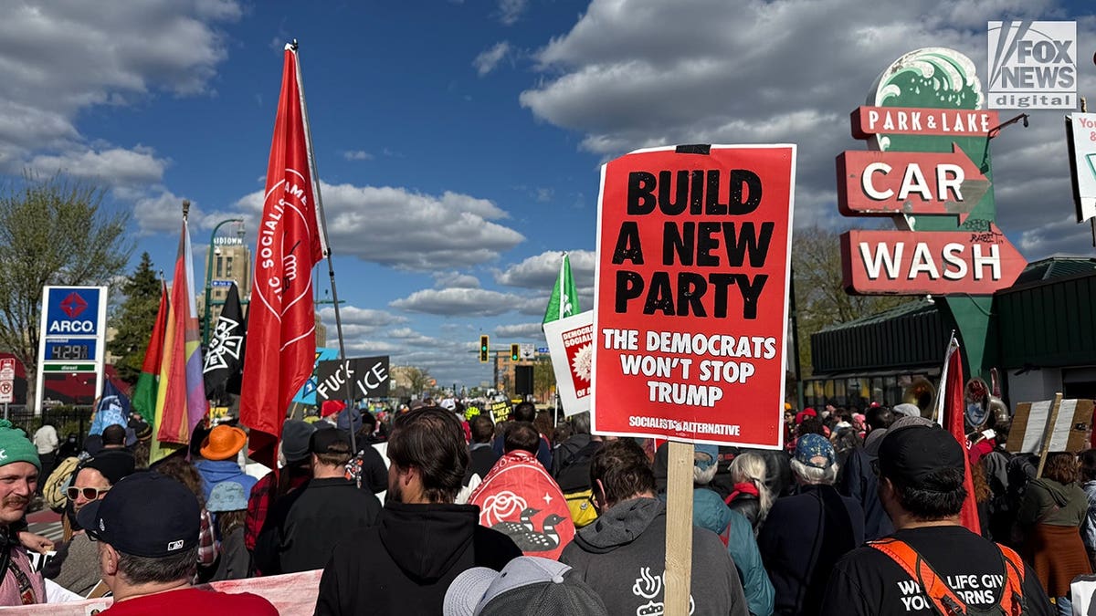 Large crowd of protesters marching on a Minneapolis street during May Day rally