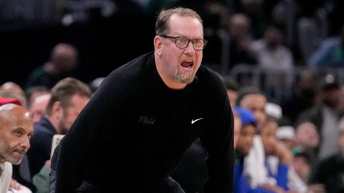 Philadelphia 76ers head coach Nick Nurse calling to players during basketball game