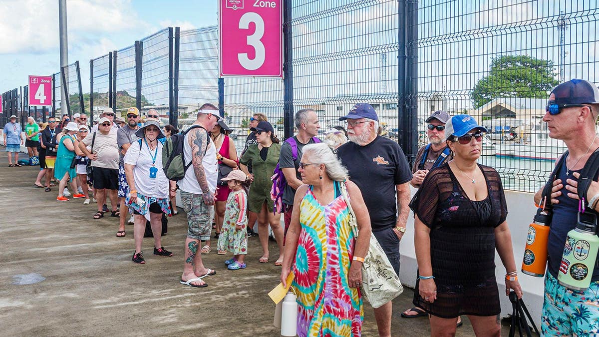 Passengers from Norwegian Cruise Line Breakaway ship waiting in a queue in St John's Antigua and Barbuda