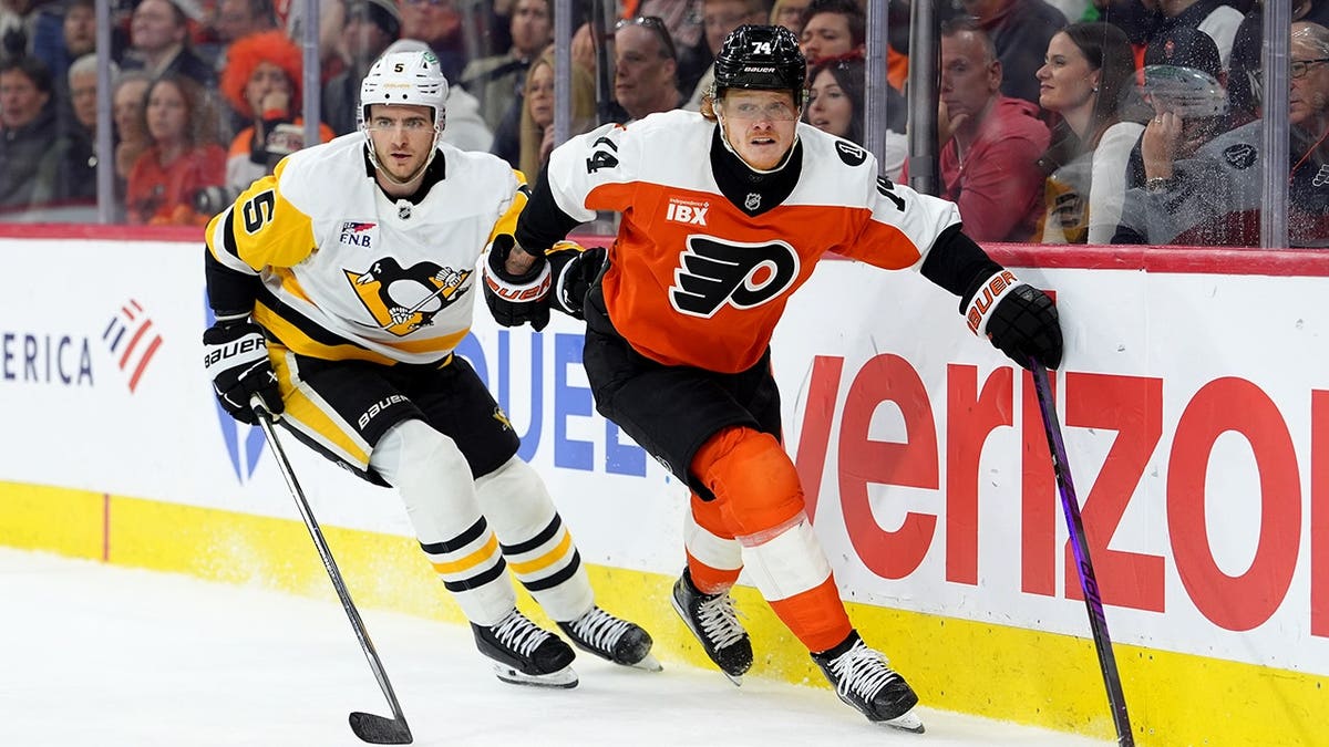 Philadelphia Flyers right wing Owen Tippett skating against Pittsburgh Penguins defenseman Ryan Shea at Xfinity Mobile Arena