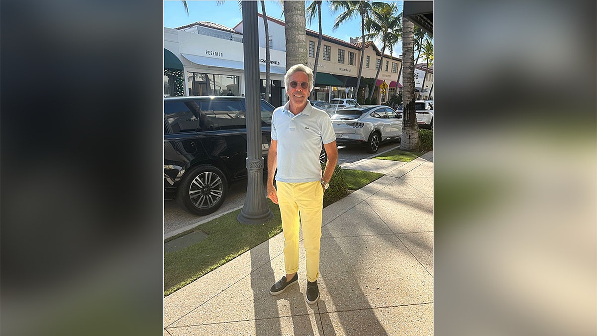 Palm Beach Pete smiling wearing yellow trousers and sunglasses