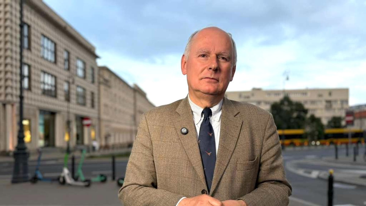 Paweł Zalewski standing and speaking in a formal setting