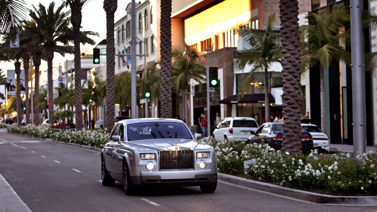 rolls royce care driving through beverly hills mall