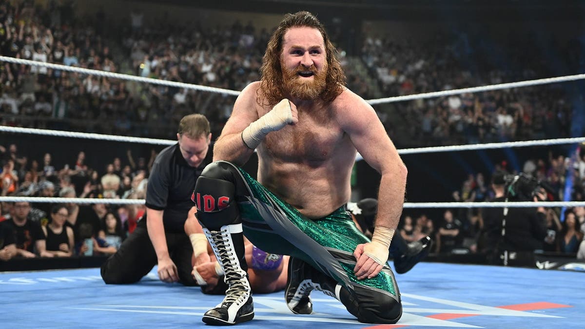 Sami Zayn celebrating his win in a wrestling ring at Olimpic Arena