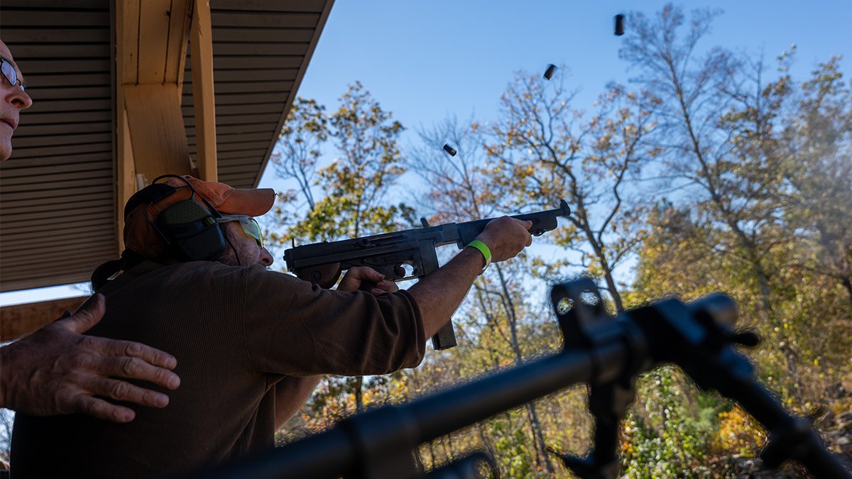 A person shoots a weapon at Second Amendment event
