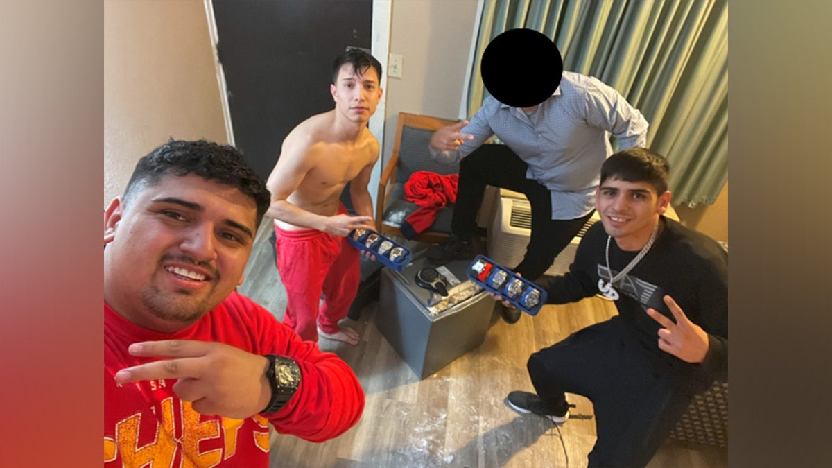 Pablo Zuniga Cartes, Ignacio Zuniga Cartes, Bastian Jimenez Freraut, and a fourth man posing with stolen safe and jewelry