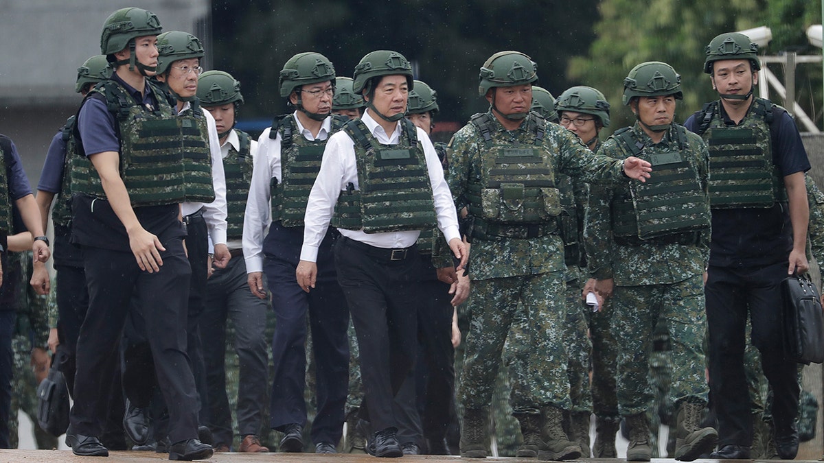 Taiwan President Lai Ching-te walking in military helmet and vest during live-fire training