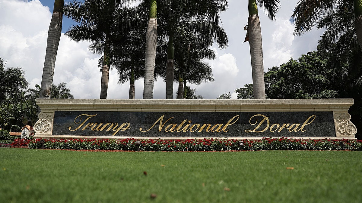 A sign reading Trump National Doral on the grounds of a golf course.