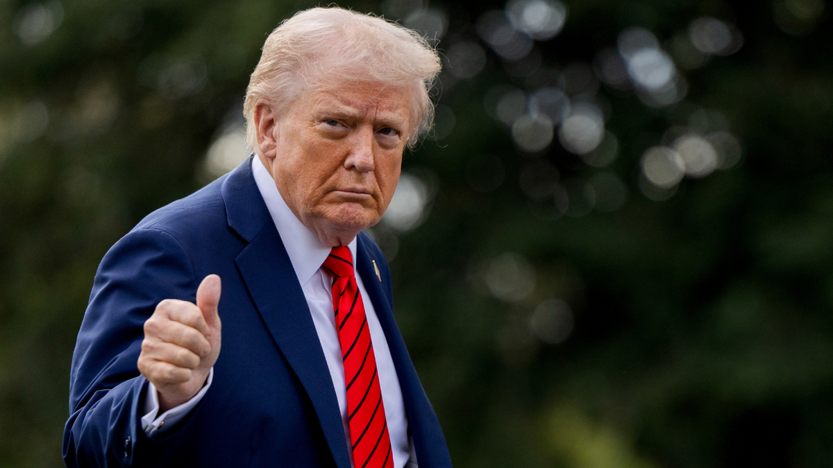 U.S. President Donald Trump walking on the South Lawn of the White House giving a thumbs up gesture
