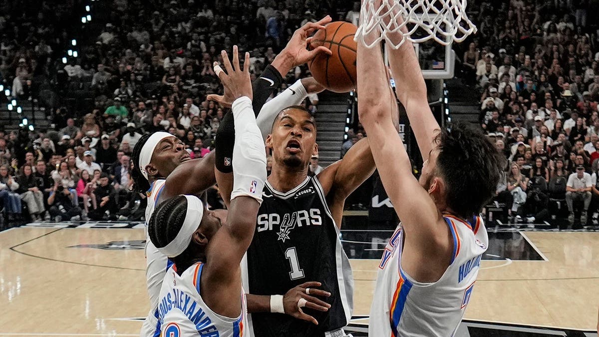 San Antonio Spurs forward Victor Wembanyama shooting basketball against Oklahoma City Thunder