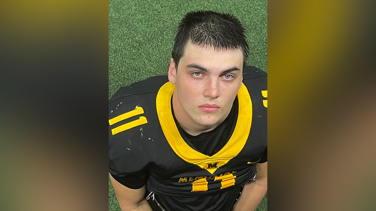 Austin Metcalf standing and smiling outdoors