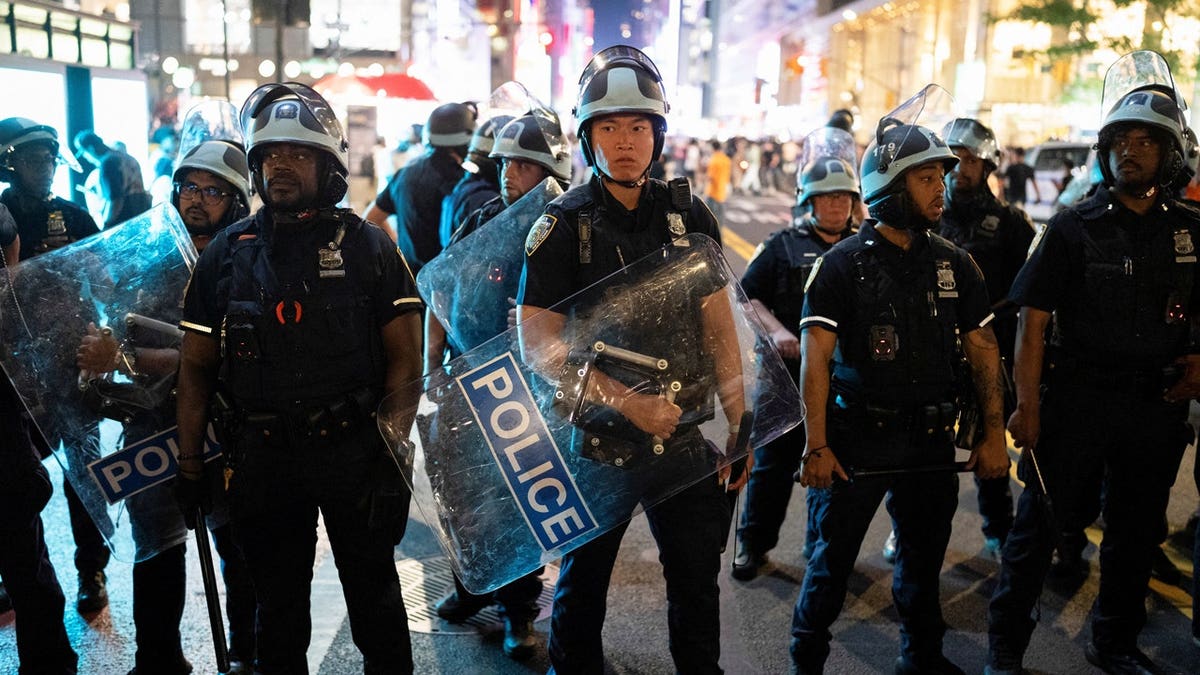 Police officers prepare to disperse the crowd after the New York Knicks' win against the San Antonio Spurs in Game 5 of the NBA Finals at Bryant Park in New York City, U.S., June 13, 2026.