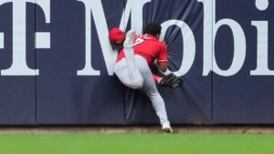 Reds’ Dane Myers carted off field after crashing into wall making acrobatic catch vs Brewers