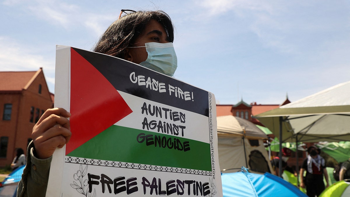 A protester holding a sign at a pro-Palestinian protest at Arizona State University in Tempe
