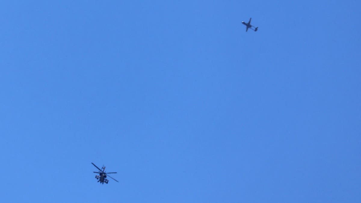 An Israeli military helicopter and drone flying above the southern border area with the Gaza Strip