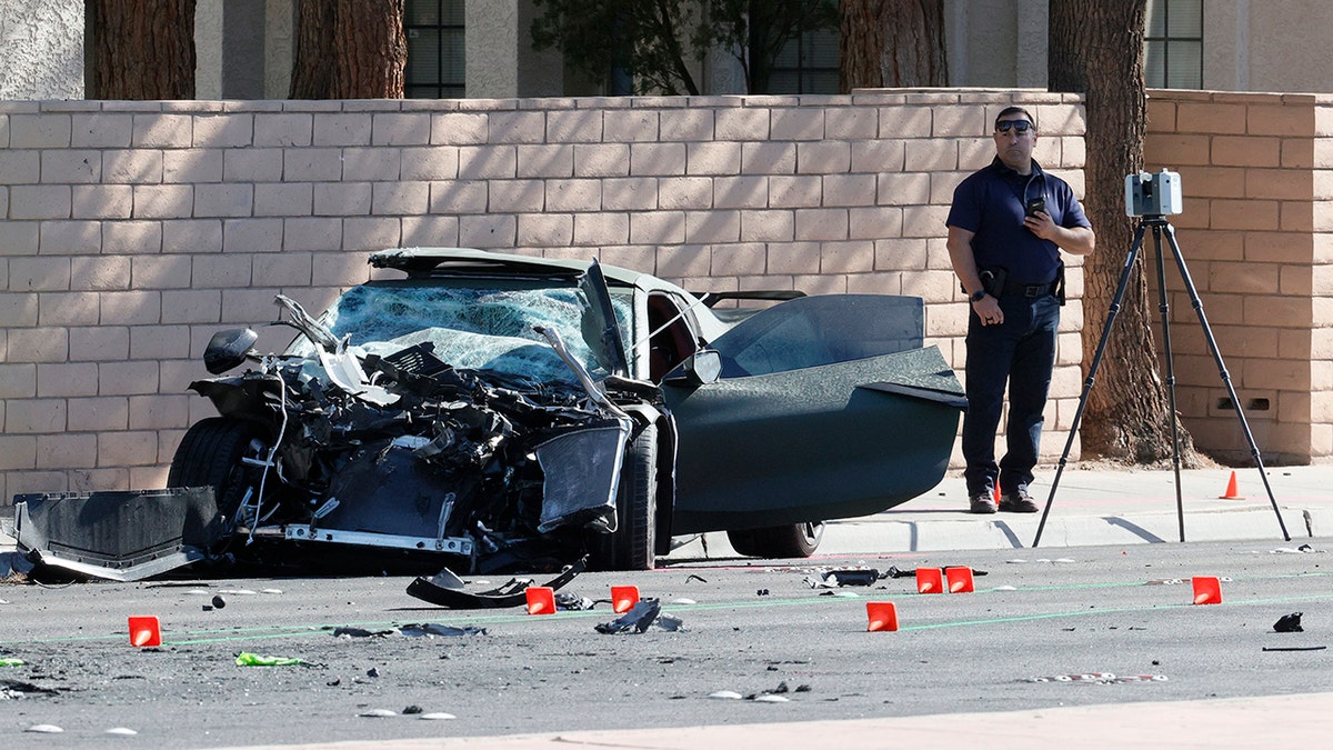 Las Vegas Raiders wide receiver Henry Ruggs III standing next to a Chevrolet Corvette at a crime scene