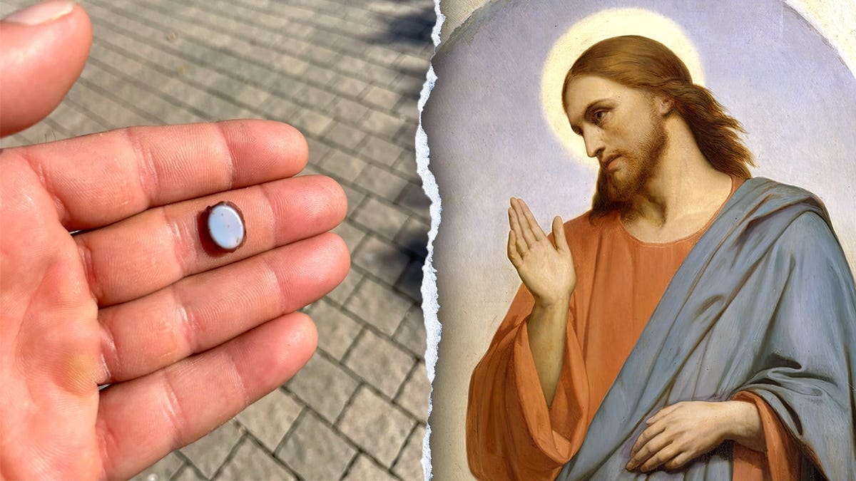 Hand holding stone next to depiction of Jesus
